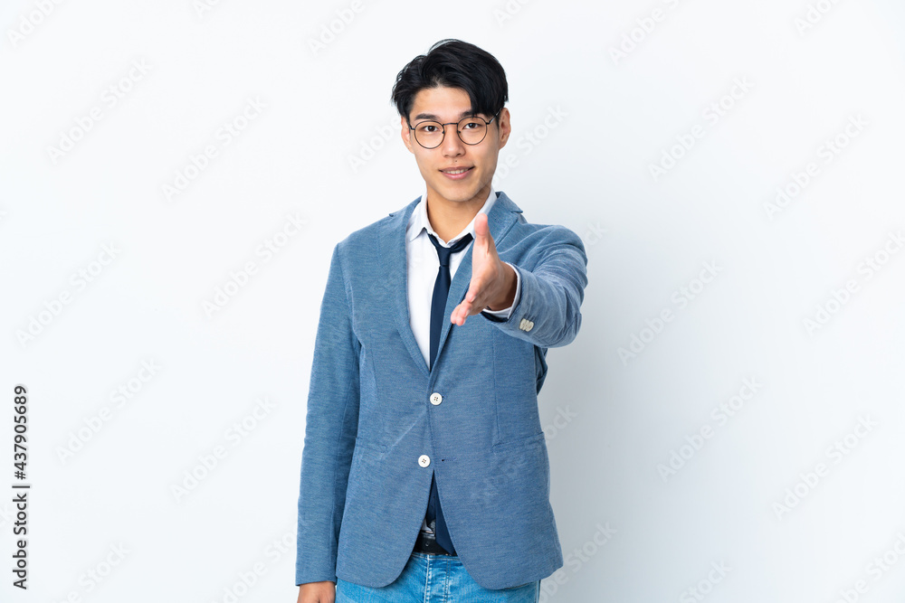 Young Chinese business man isolated on white background shaking hands for closing a good deal Young Chinese business man isolated on white background shaking hands for closing a good deal