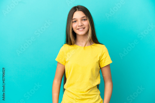 Little girl over isolated blue background laughing
