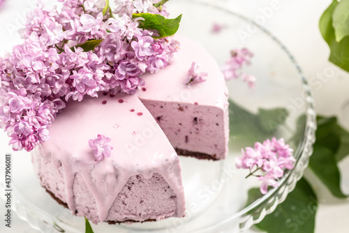 Wallpaper Mural velvet mousse cake with blueberries decorated with a bouquet of purple blooming lilac, French cuisine, postcard, background Torontodigital.ca