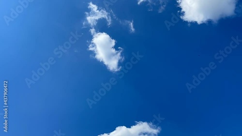 White clouds moving in the blue sky on a sunny summer day. Beauty concept of nature. HD video shooting