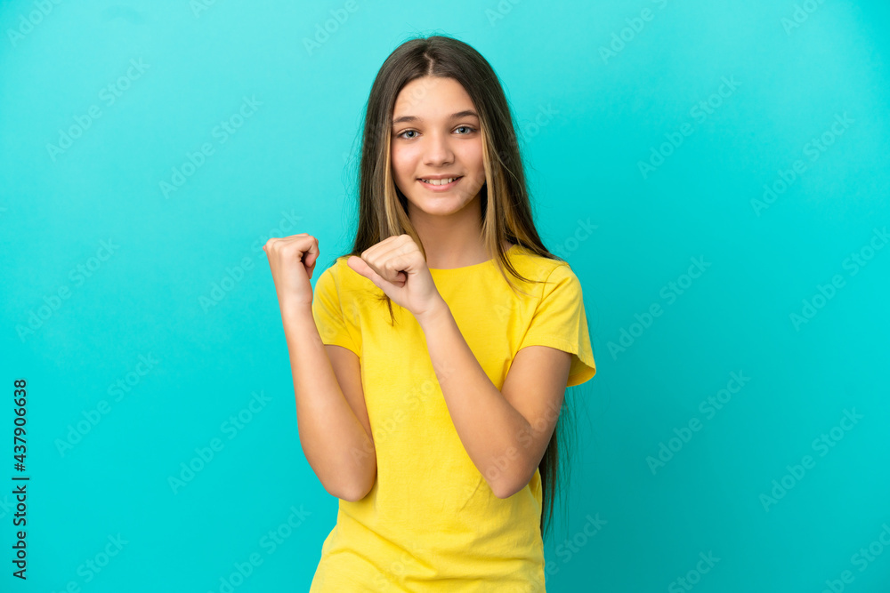 Little girl over isolated blue background pointing to the side to present a product