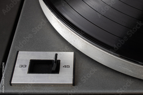Close-up of speed rotation switch set to 45 RPM on vintage turntable vinyl record player photo