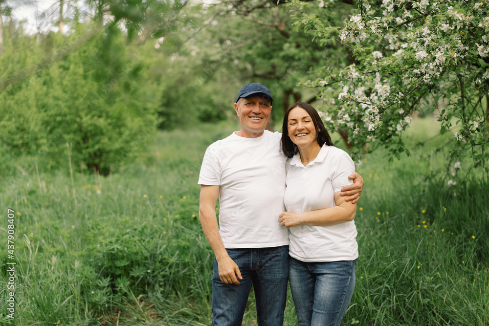 Portrait of an adult couple in love in the garden. Portrait of an adult couple in love in the garden.