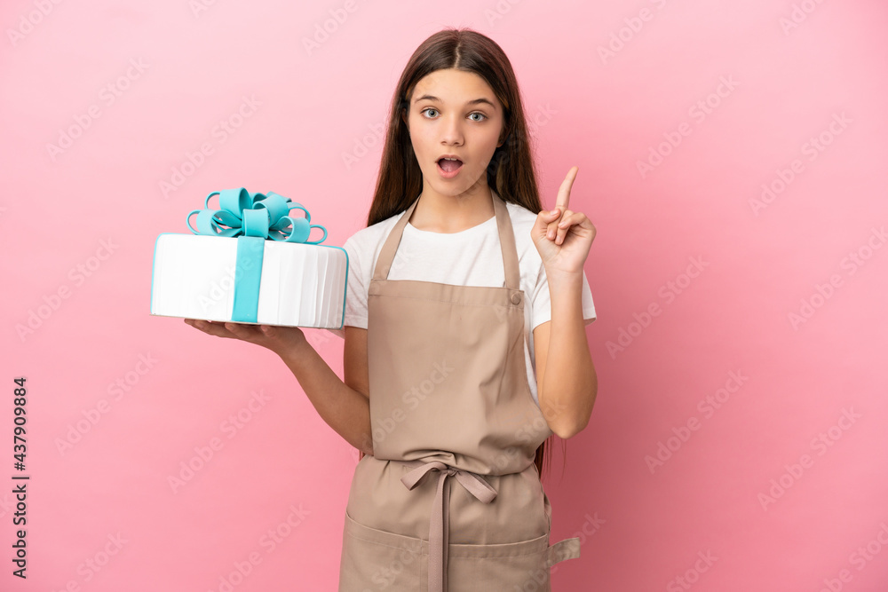 Little girl with a big cake over isolated pink background thinking an idea pointing the finger up Little girl with a big cake over isolated pink background thinking an idea pointing the finger up