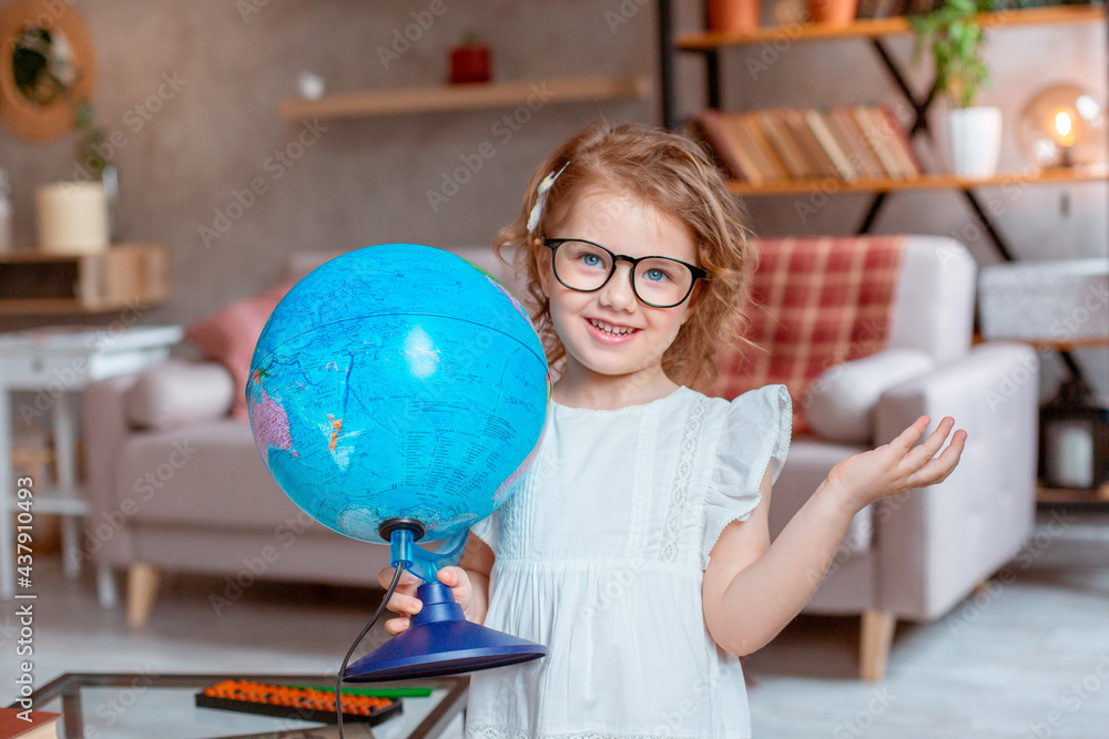little schoolgirl girl holding a globe, Happy cute little girl doing homework, holding a globe, studying little schoolgirl girl holding a globe, Happy cute little girl doing homework, holding a globe, studying