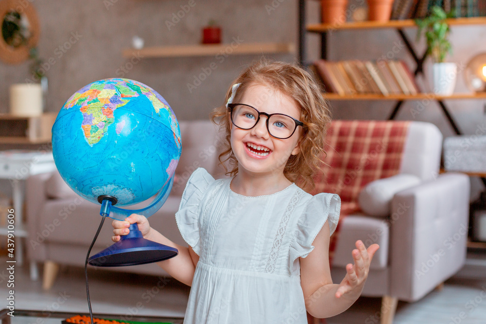 little schoolgirl girl holding a globe, Happy cute little girl doing homework, holding a globe, studying little schoolgirl girl holding a globe, Happy cute little girl doing homework, holding a globe, studying