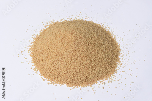 Photos pile of wholemeal cous-cous on white background