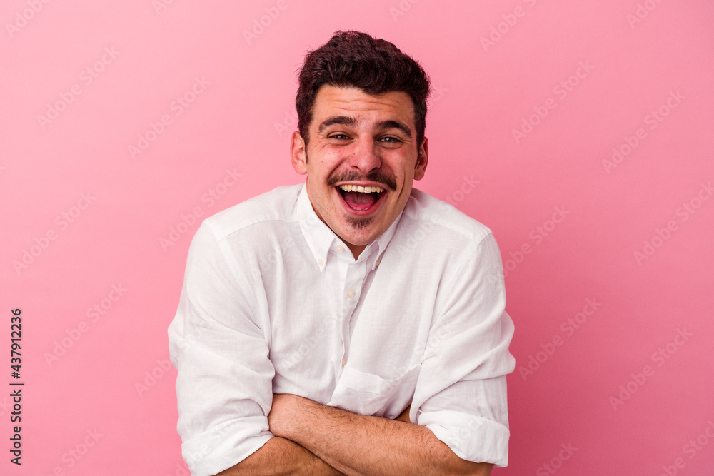 Young caucasian man isolated on pink background laughing and having fun. Young caucasian man isolated on pink background laughing and having fun.