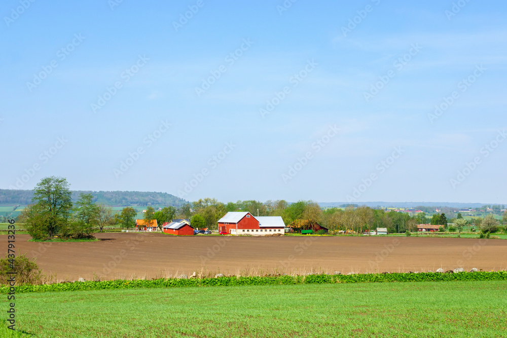 Rural view with fields and farms in the swedish countryside Rural view with fields and farms in the swedish countryside