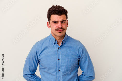Young caucasian man isolated on white background sad, serious face, feeling miserable and displeased.