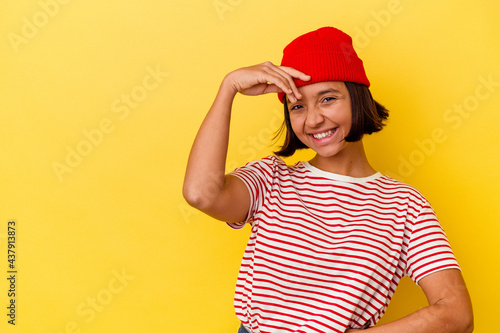 Young mixed race woman isolated on yellow background laughing happy, carefree, natural emotion.