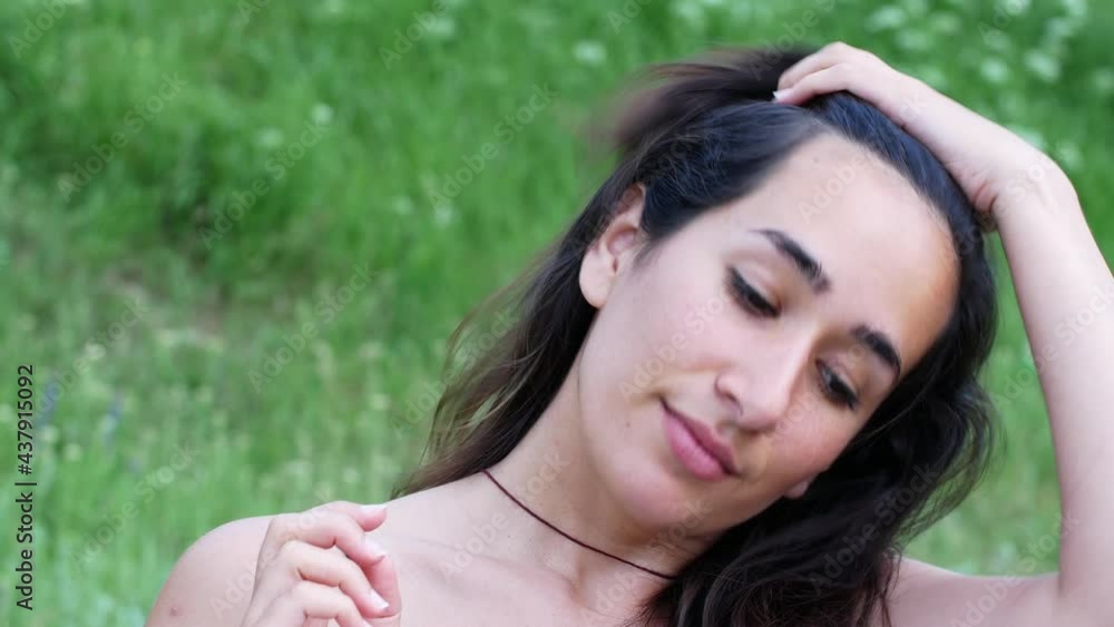 A beautiful young girl at sunset straightens her dark hair slowly fluttering in the wind with her hands.
A beautiful young girl at sunset straightens her dark hair slowly fluttering in the wind with her hands.