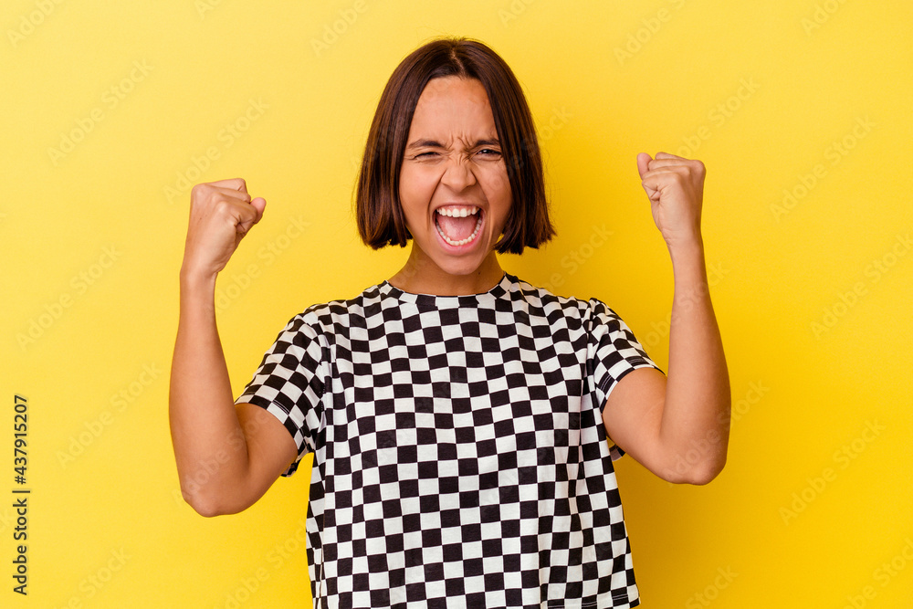 Young mixed race woman isolated on yellow background cheering carefree and excited. Victory concept. Young mixed race woman isolated on yellow background cheering carefree and excited. Victory concept.