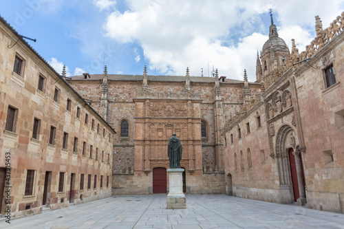 View at the patio de escuelas, central University plaza with Salamanca Museum and University of Salamanca buildings and Fr Luis de Leon statue photo