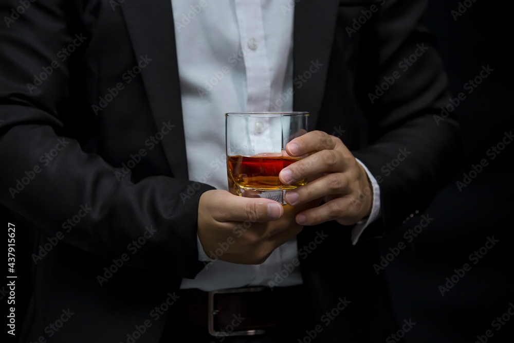 Closeup businessmen holding a glass of whiskey Closeup businessmen holding a glass of whiskey