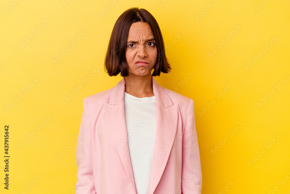 Young mixed race woman isolated on yellow background sad, serious face, feeling miserable and displeased. Young mixed race woman isolated on yellow background sad, serious face, feeling miserable and displeased.