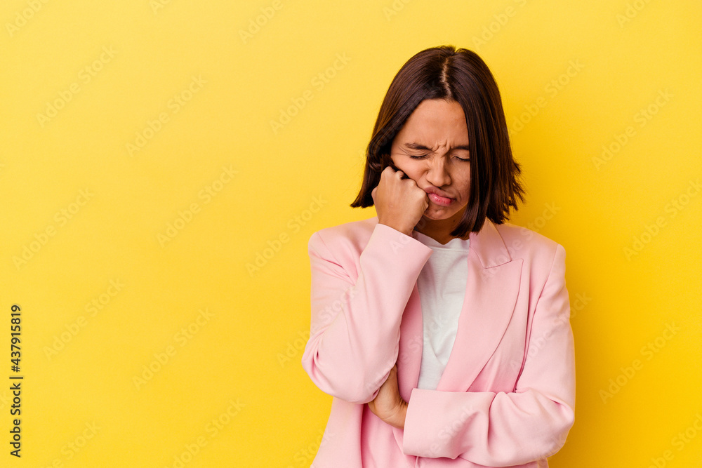 Young mixed race woman isolated on yellow background who feels sad and pensive, looking at copy space. Young mixed race woman isolated on yellow background who feels sad and pensive, looking at copy space.