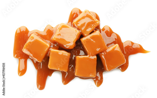 Heap of sweet caramel candies with topping isolated on white, top view