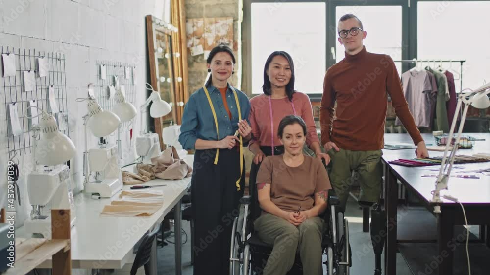 Panning portrait of diverse team of male and female fashion designers in studio Panning portrait of diverse team of male and female fashion designers in studio