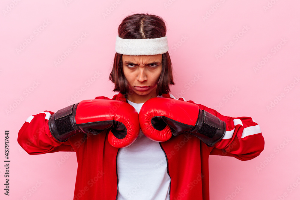 Young mixed race sport woman with boxing gloves isolated on pink background Young mixed race sport woman with boxing gloves isolated on pink background