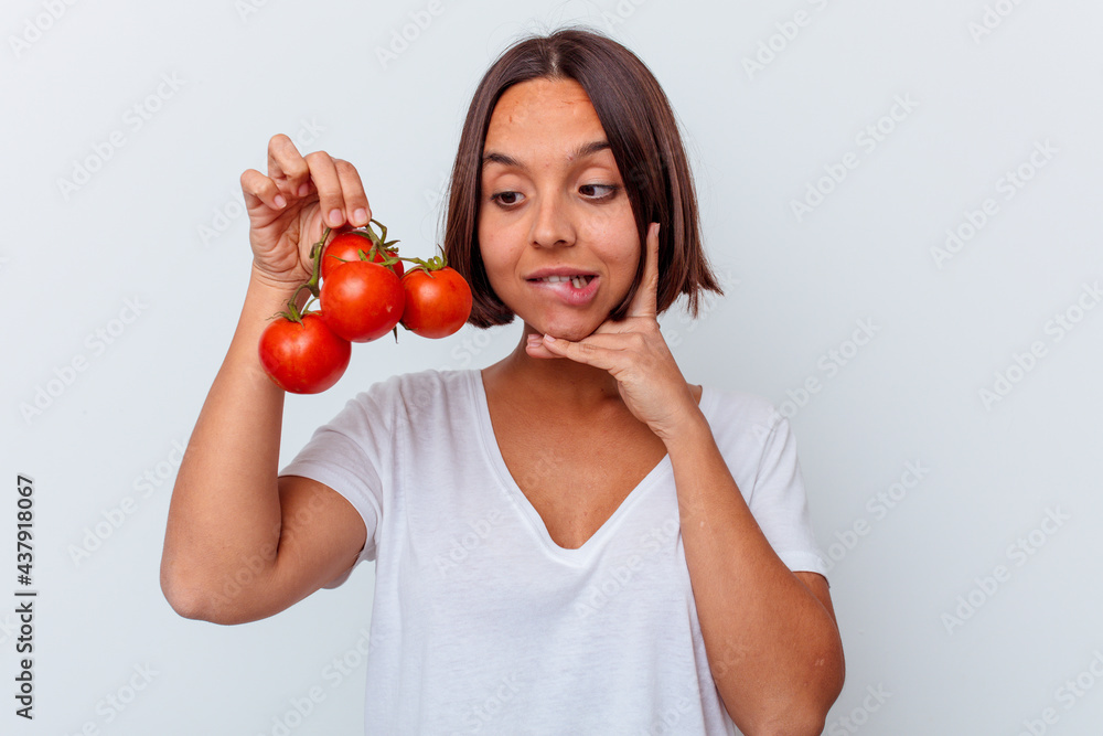 Young mixed race woman holding tomatoes isolated on white background Young mixed race woman holding tomatoes isolated on white background