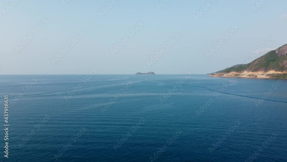 Aerial shot of fishing boats floating in the sea next to the islands Aerial shot of fishing boats floating in the sea next to the islands