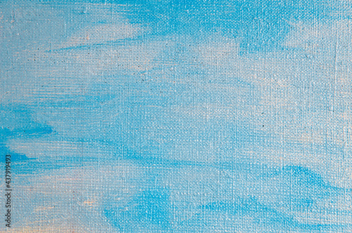 creative sky background: temporary image of cloudy blue heaven on a rough canvas with colored primer