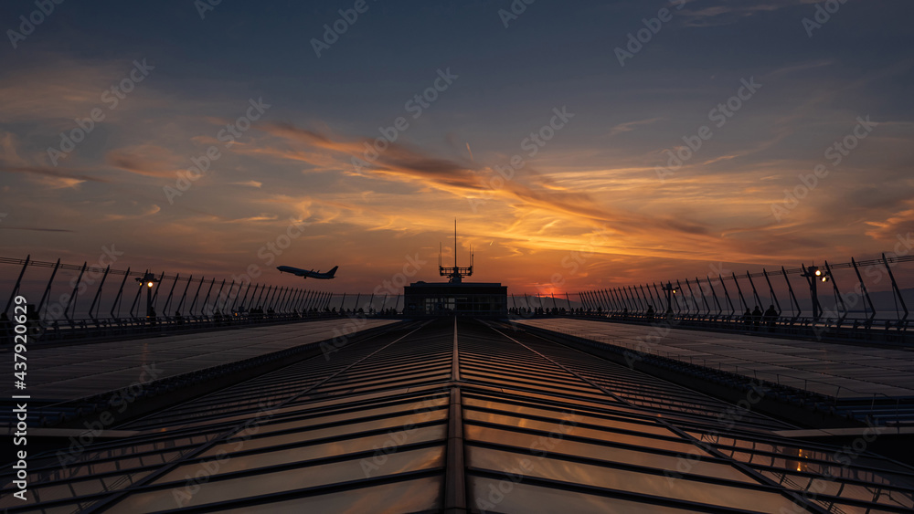 beautiful sunset landscape in airport with airplane is taking off.