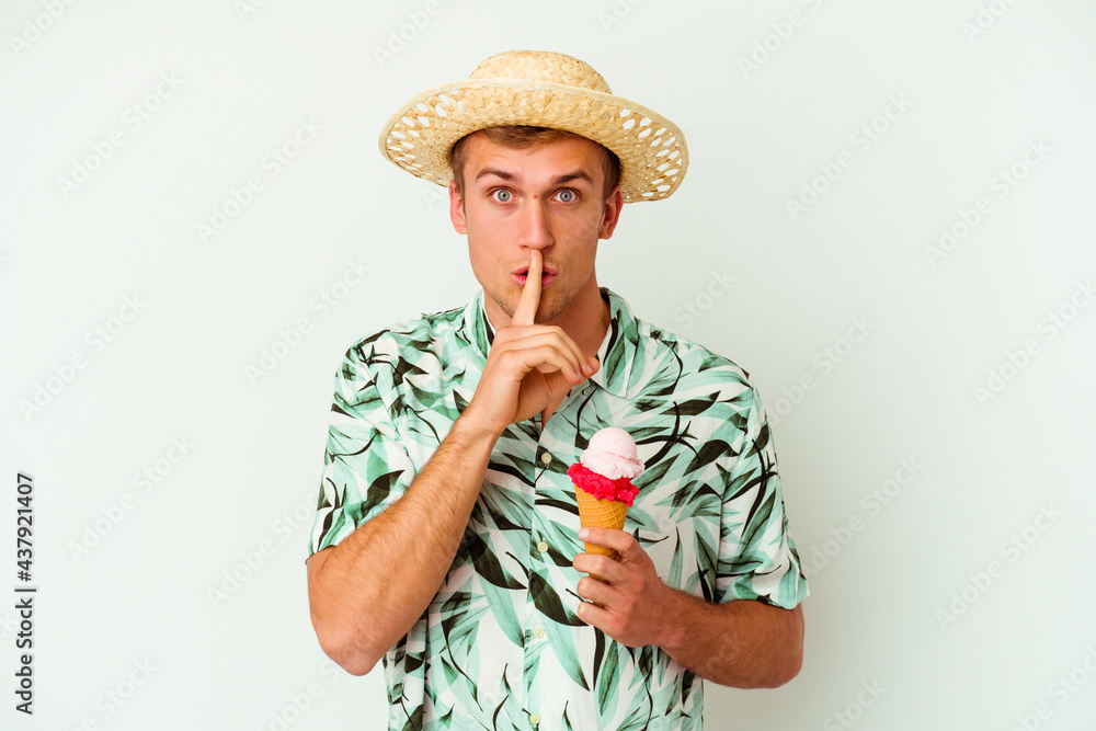 Fototapeta premium Young caucasian man wearing a summer clothes and holding a ice cream isolated on white background