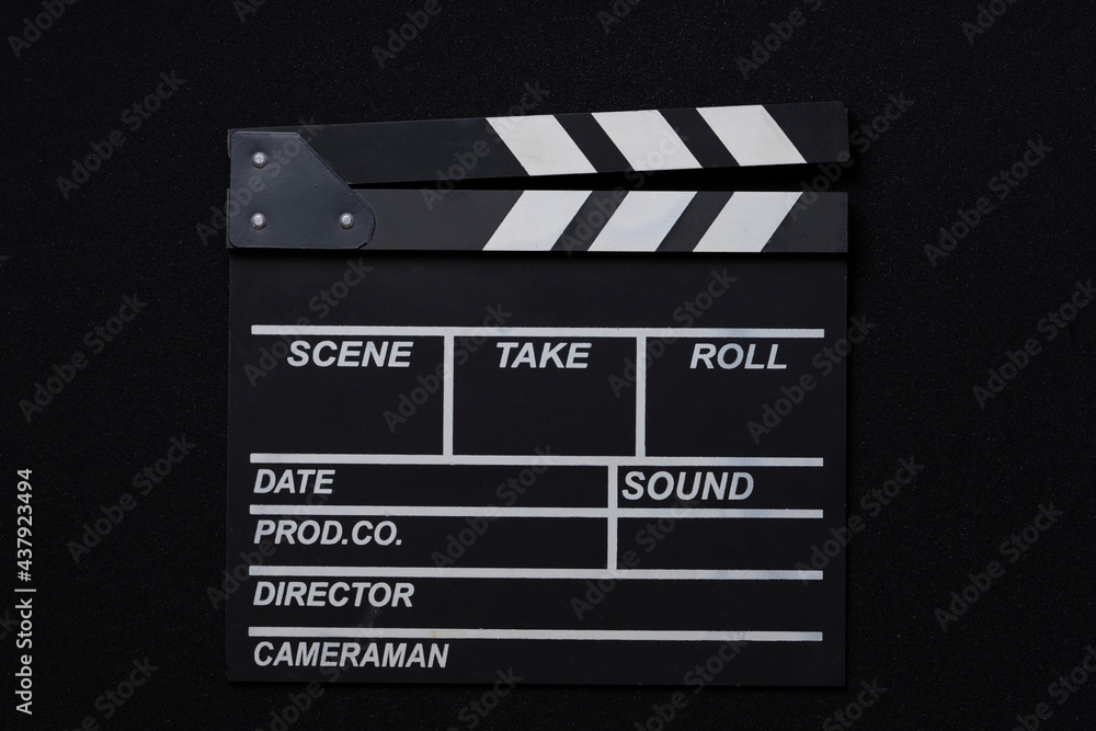 Obraz premium movie clapper on black table background; film, cinema and video photography concept
