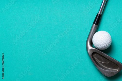 golf ball and golf club on green background, sport concept