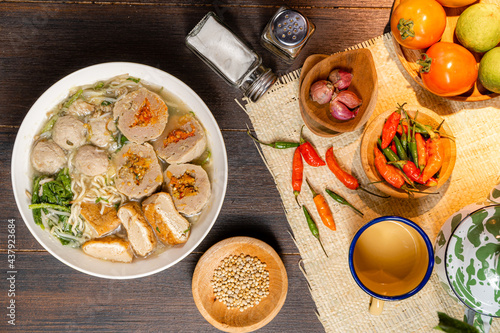 Bakso or baso is an Indonesian meatball, Its texture is similar to the Chinese beef ball, fish ball, or pork ball. The word bakso refer the complete dish of beef broth soup, noodle, tofu and bok choy. photo