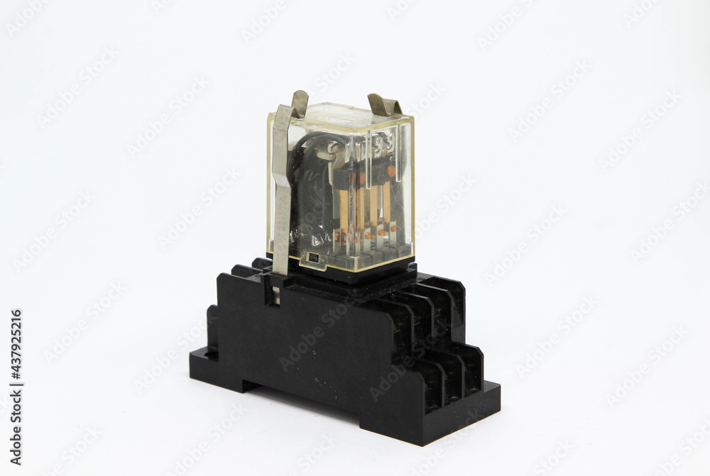 An electrical auxiliary relay in transparent plastic cases on white background. An electrical auxiliary relay in transparent plastic cases on white background.