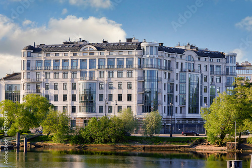 Houses on the embankment are reflected in Srednyaya Nevka river of Petersburg