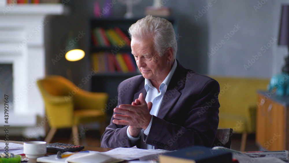 Fototapeta premium Senior businessman doing paperwork at home office