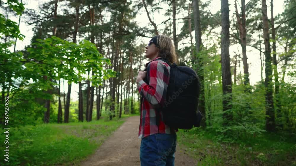 Man with rucksack walking in the forest. Man with rucksack walking in the forest.
