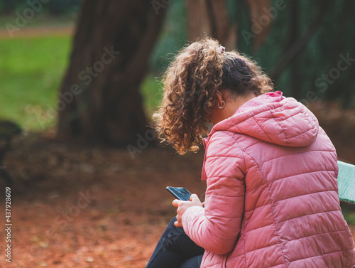 person with mobile phone in nature