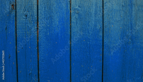 Wooden boards painted in blue. Rough and cracked surface. Old wood and paint.Background and texture.