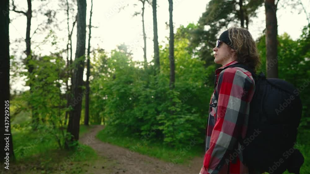 Man with rucksack walking in the forest. Man with rucksack walking in the forest.