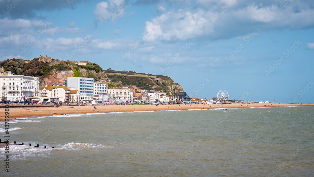 Hastings, East Sussex, England. The seafront to the popular seaside resort with its landmark castle visible on the hill.