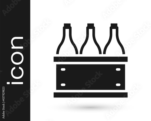 Black Bottles of wine in a wooden box icon isolated on white background. Wine bottles in a wooden crate icon. Vector