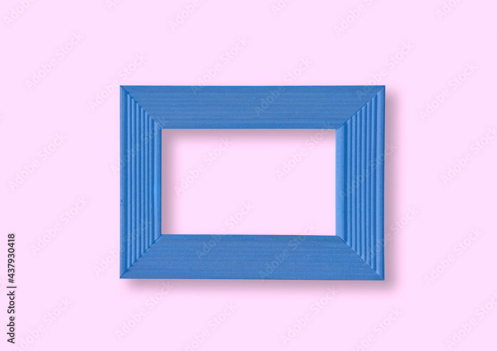 Blue wooden frame on a pink wall Blue wooden frame on a pink wall