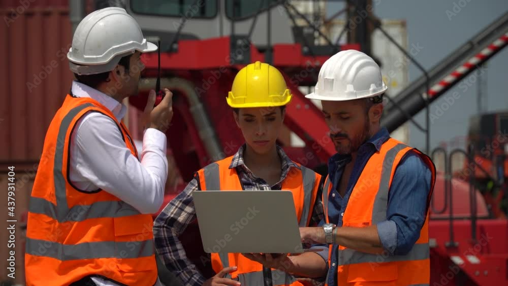 group of harbor worker with foreman talking on the walkie-talkie control loading Containers box and using laptop computer checking list inventory at warehouse logistic in Cargo freight ship group of harbor worker with foreman talking on the walkie-talkie control loading Containers box and using laptop computer checking list inventory at warehouse logistic in Cargo freight ship