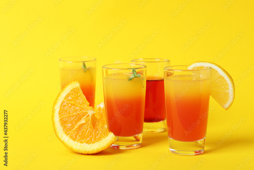 Tequila sunrise cocktails and ingredients on yellow background Tequila sunrise cocktails and ingredients on yellow background