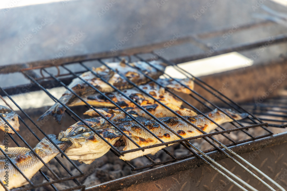 Delicious sea bass and golden fish barbecued on the charcoal