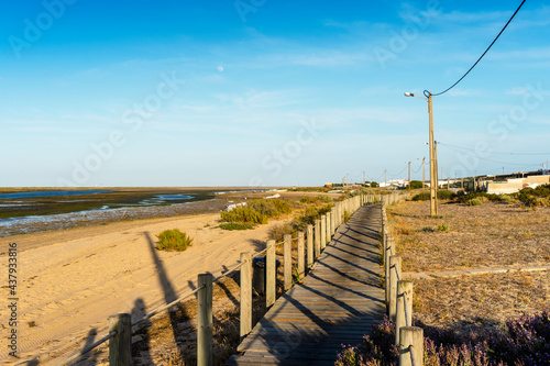 Fototapeta Naklejka Na Ścianę i Meble -  Wooden walkways with view on wetlands of Ria Formosa on Faro Beach Peninsula, Algarve, Portugal