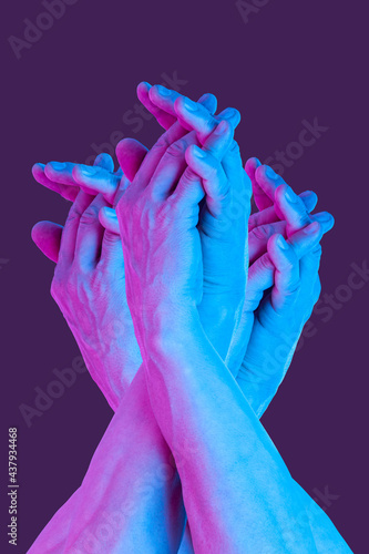 Hands in a surreal style in violet blue neon colors. Modern psychedelic creative element with human palm for posters, banners, wallpaper. Copy space for text. Magazine style template. Pop art culture.
