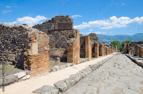 Famous landmark of ancient and historic city temple ruins with columns and walls on archeologic site museum Pompeji Pompeii excavation site in Italy near Naples and Vesuv Volcano photo