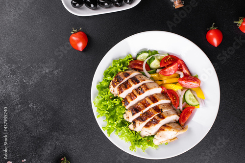 salad grilled chicken breast vegetables tomato, cucumber, onion mix poultry meat organic dish on the table healthy food meal snack copy space food background rustic. top view keto or paleo diet