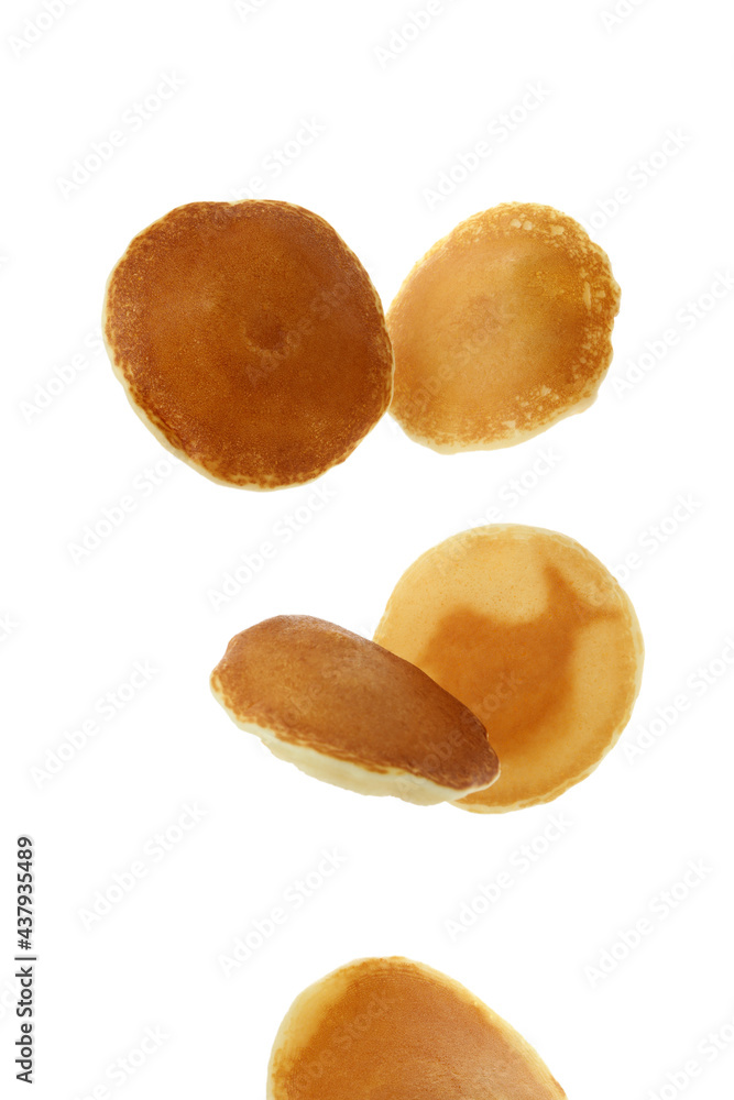 Tasty falling pancakes isolated on white background Tasty falling pancakes isolated on white background